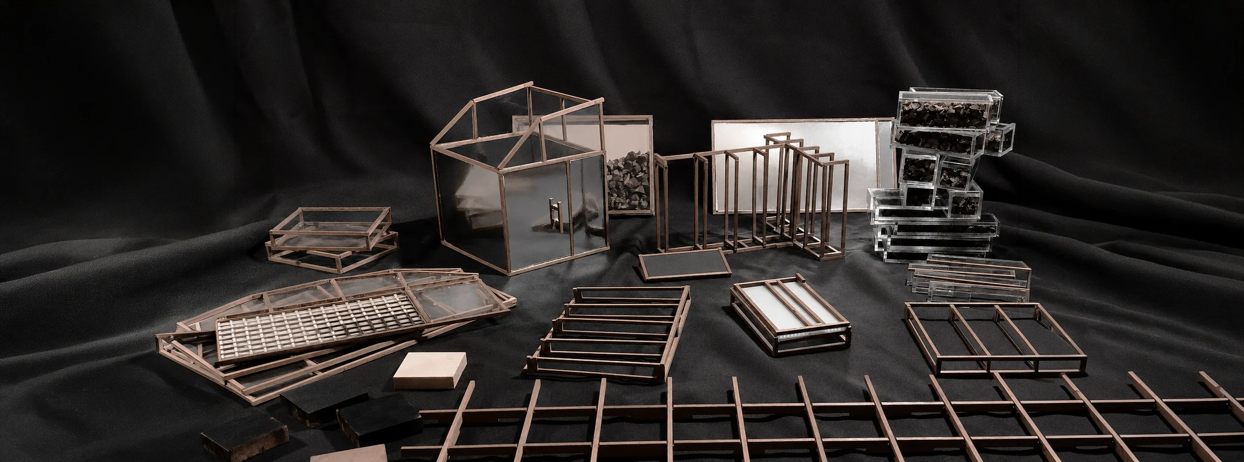 Architectural and object studies arranged across black fabric